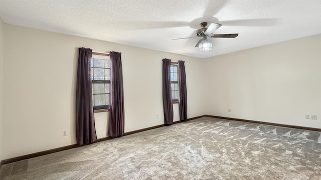 unfurnished room featuring a textured ceiling, carpet floors, and ceiling fan