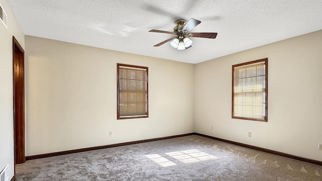 empty room with a textured ceiling, ceiling fan, and light carpet