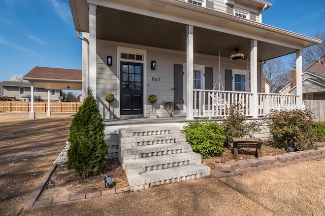 view of exterior entry with a porch