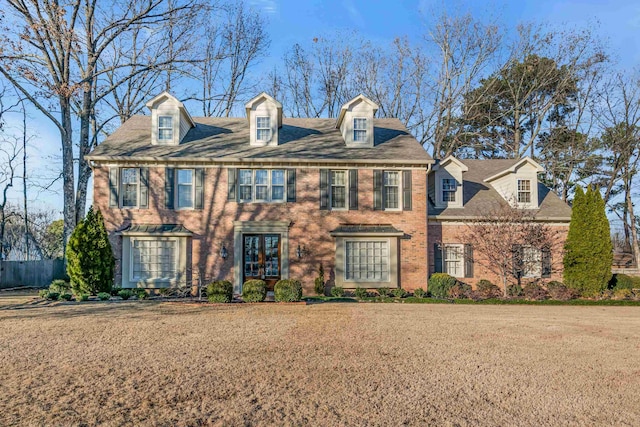 colonial-style house with a front yard