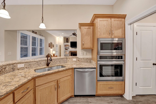 kitchen featuring hanging light fixtures, ceiling fan, sink, and stainless steel appliances