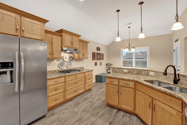 kitchen with sink, stainless steel appliances, decorative light fixtures, and a notable chandelier