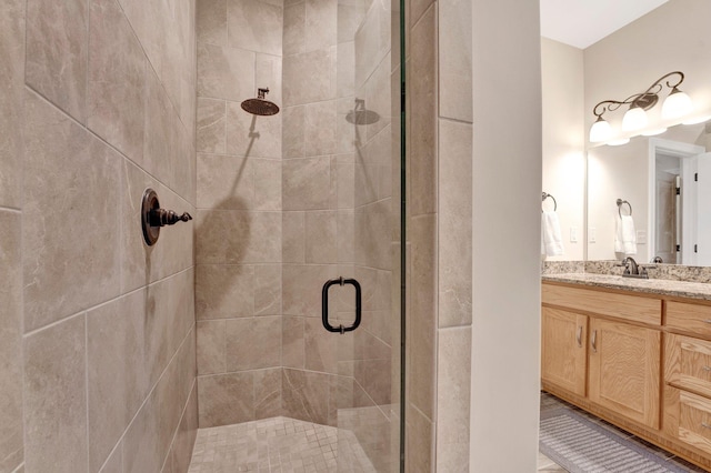 bathroom with vanity and a shower with shower door