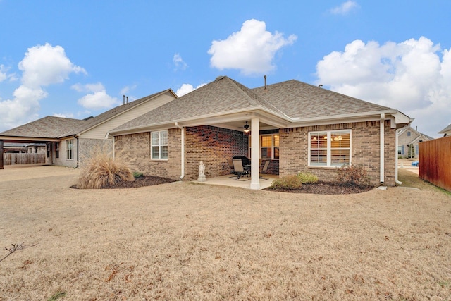 rear view of property with ceiling fan and a patio area