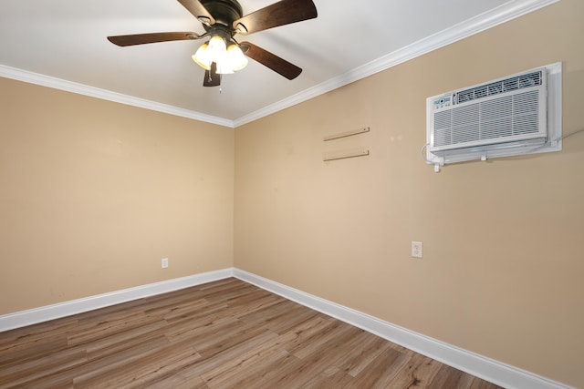 spare room with a wall mounted air conditioner, hardwood / wood-style flooring, ceiling fan, and crown molding