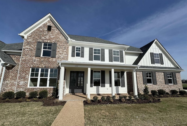 view of front of house featuring covered porch and a front lawn