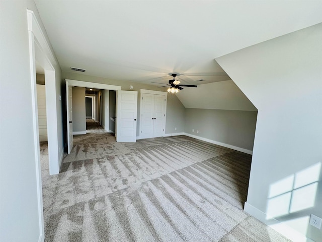 bonus room with lofted ceiling, ceiling fan, and light carpet