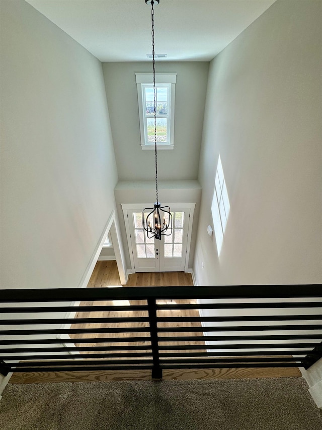 interior space featuring a high ceiling and an inviting chandelier