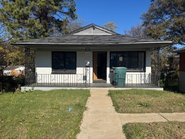 bungalow-style home featuring a porch and a front yard