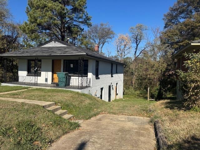 view of front facade with a front yard and covered porch