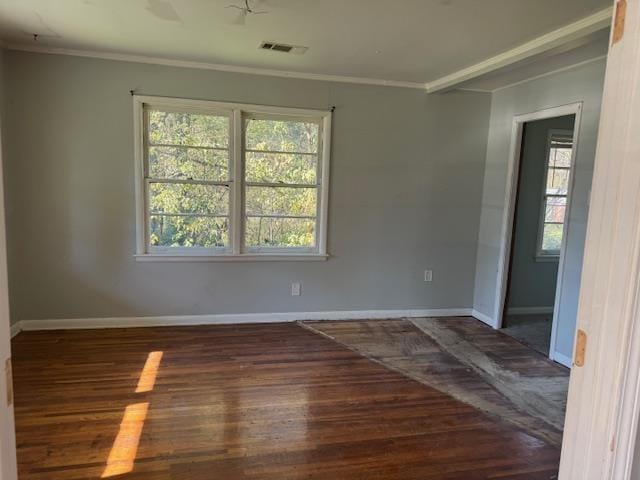 unfurnished room featuring dark wood-type flooring and crown molding