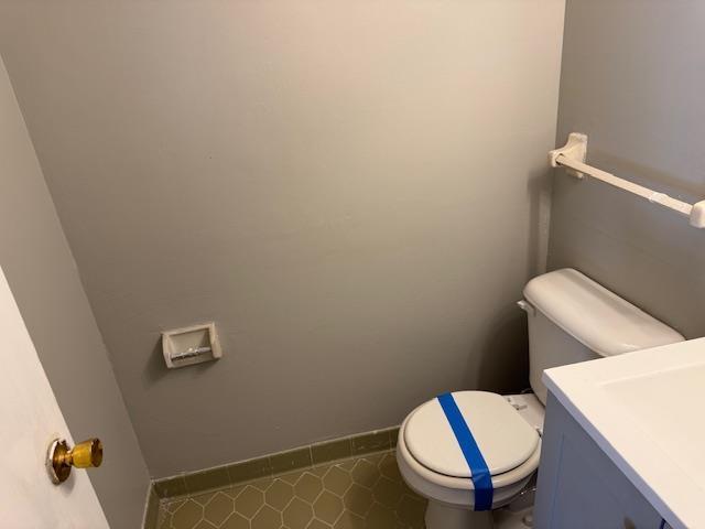 bathroom featuring tile patterned flooring, vanity, and toilet