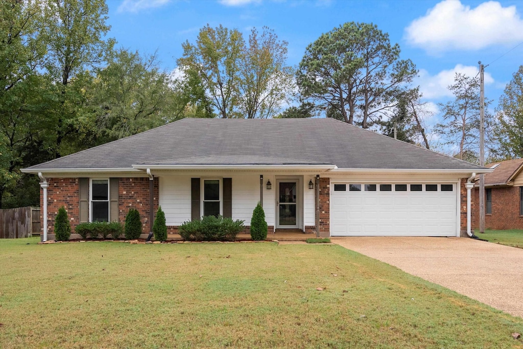 ranch-style house with a garage and a front yard