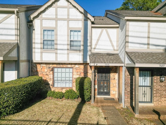 view of exterior entry with a lawn