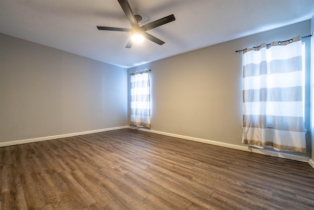 unfurnished room with dark hardwood / wood-style flooring and ceiling fan