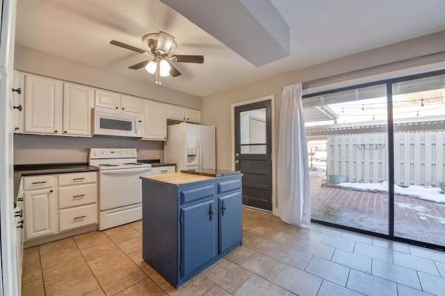 kitchen with white cabinets, a center island, white appliances, wooden counters, and blue cabinetry