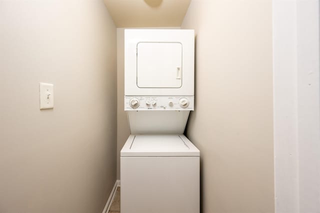 laundry room with stacked washer / drying machine