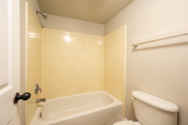 bathroom with washtub / shower combination and toilet