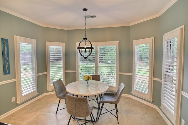 dining space with an inviting chandelier, crown molding, and light tile patterned floors