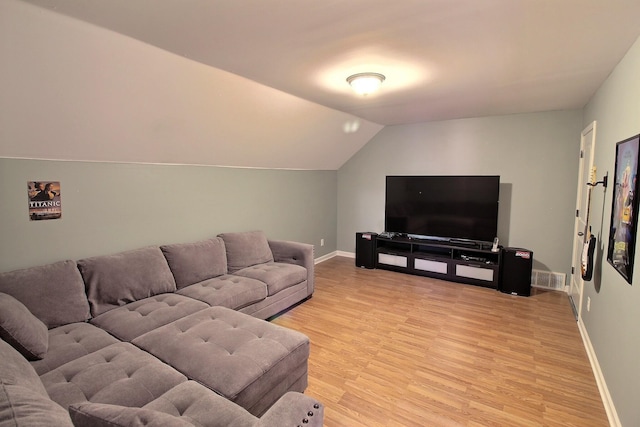 living room with lofted ceiling and light hardwood / wood-style flooring