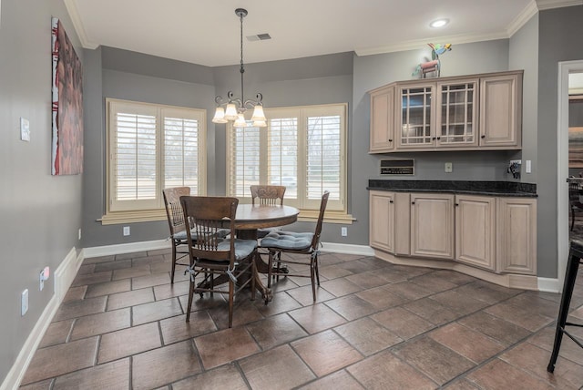 dining space featuring crown molding and a chandelier