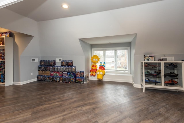 playroom with dark hardwood / wood-style flooring and vaulted ceiling