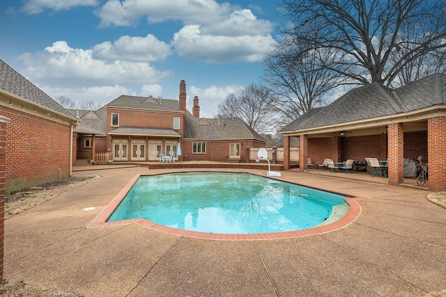 view of swimming pool featuring a patio area