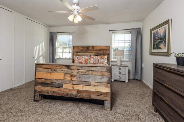 bedroom with multiple windows, carpet floors, and ceiling fan