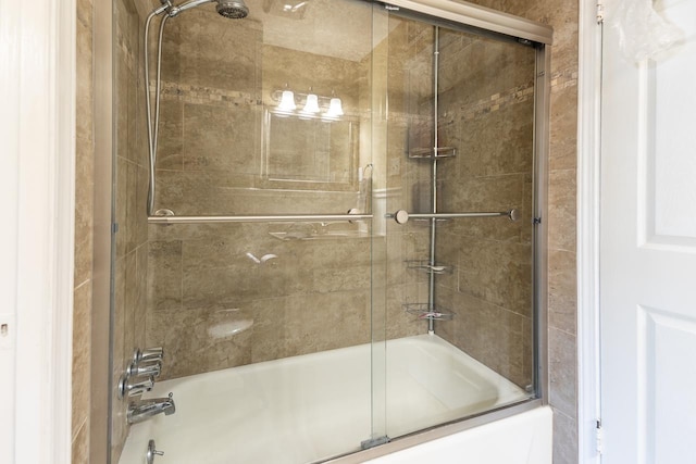 bathroom featuring bath / shower combo with glass door