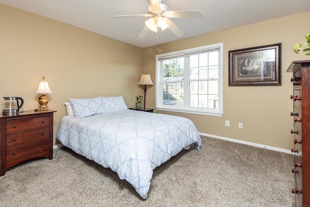 bedroom with ceiling fan and light carpet