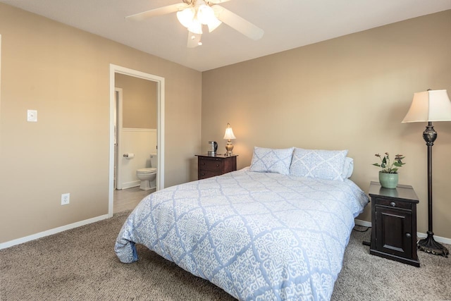 carpeted bedroom featuring ensuite bath and ceiling fan