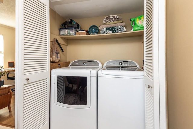 clothes washing area with washing machine and dryer and ornamental molding