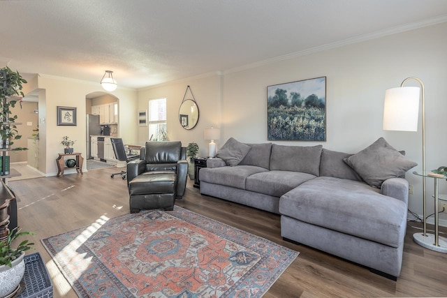 living room featuring ornamental molding, a textured ceiling, and wood-type flooring