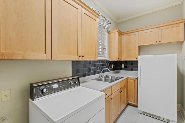 washroom with sink, washer / clothes dryer, cabinets, ornamental molding, and light tile patterned floors