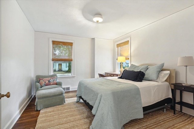 bedroom with dark hardwood / wood-style floors