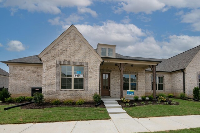 view of front of home featuring a porch and a front lawn