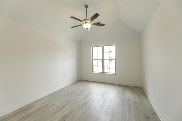 spare room with light hardwood / wood-style floors, ceiling fan, and lofted ceiling