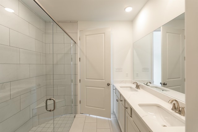 bathroom with an enclosed shower, vanity, and tile patterned floors