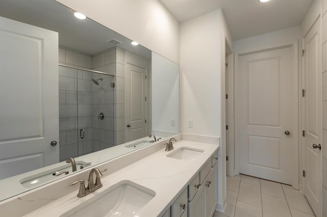 bathroom with vanity, tile patterned floors, and a shower with shower door