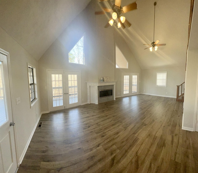 unfurnished living room featuring high vaulted ceiling, french doors, ceiling fan, and dark hardwood / wood-style floors