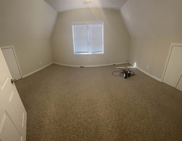 bonus room featuring lofted ceiling and carpet flooring