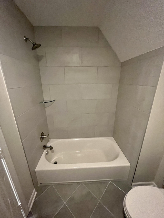 bathroom with toilet, tile patterned flooring, and shower / tub combination