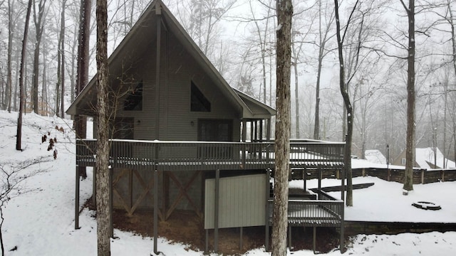 snow covered property featuring a deck