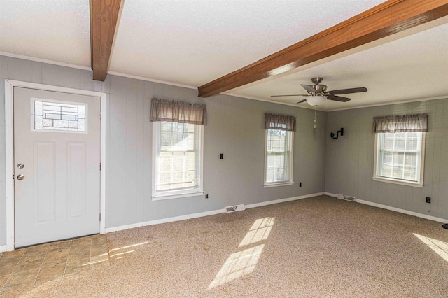 carpeted entrance foyer with a textured ceiling, beam ceiling, and ceiling fan