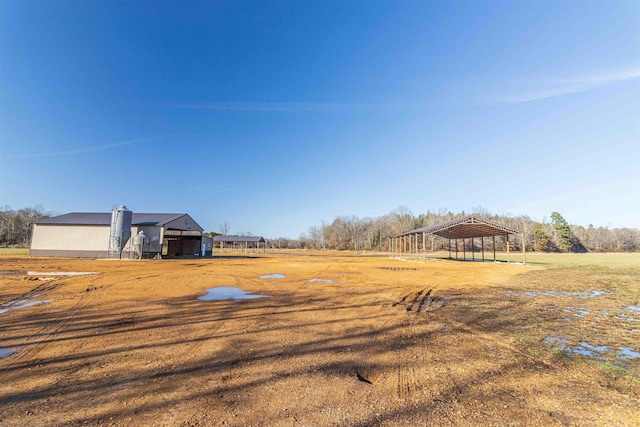 view of yard featuring a carport and a rural view