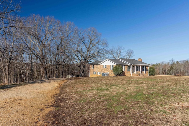 single story home with a front yard and covered porch