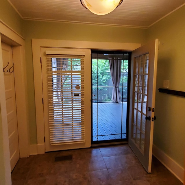 doorway featuring ornamental molding, french doors, and dark tile patterned floors