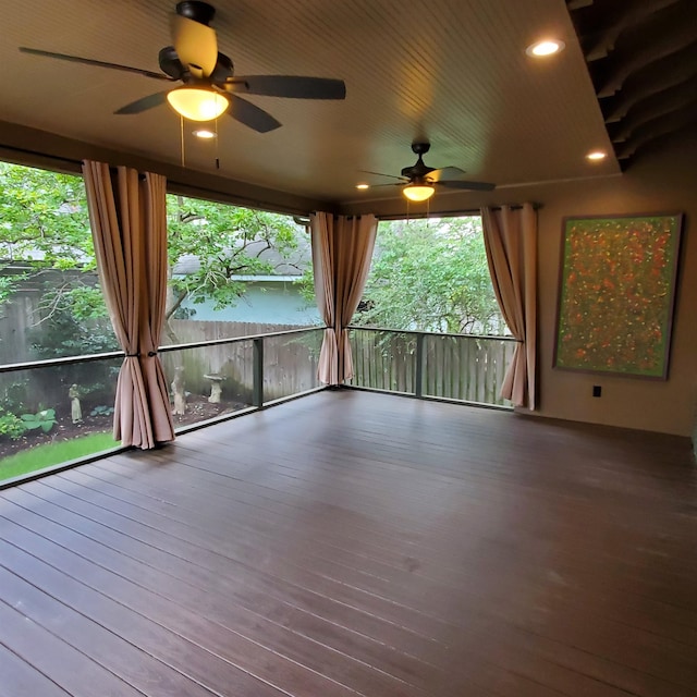 interior space featuring ceiling fan and plenty of natural light