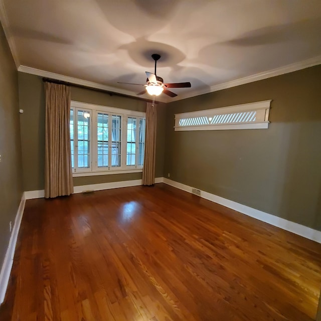 unfurnished room featuring ceiling fan, crown molding, and dark hardwood / wood-style flooring