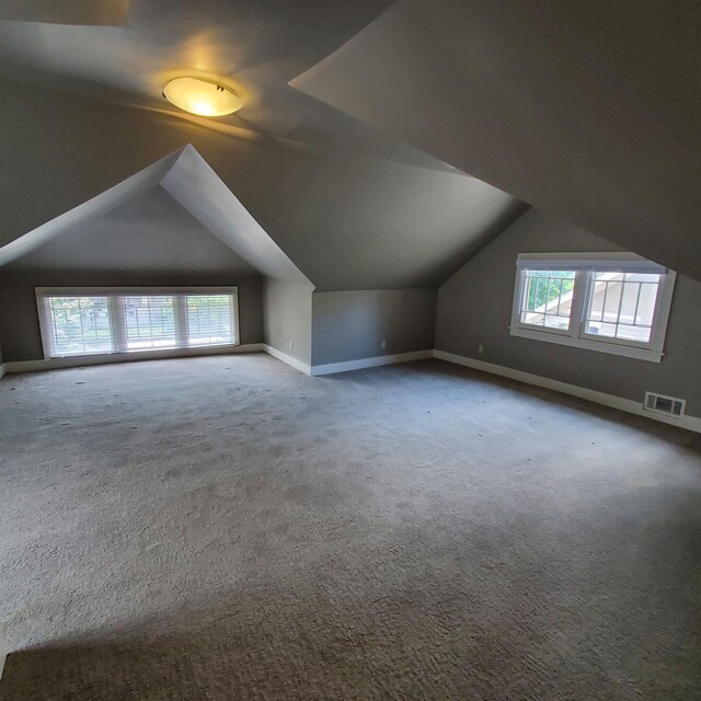 bonus room featuring lofted ceiling and carpet floors